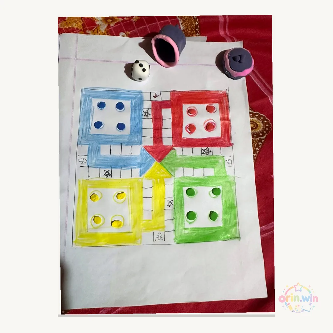Orin's colorful drawing with blue, red, yellow, and green dice-like houses.