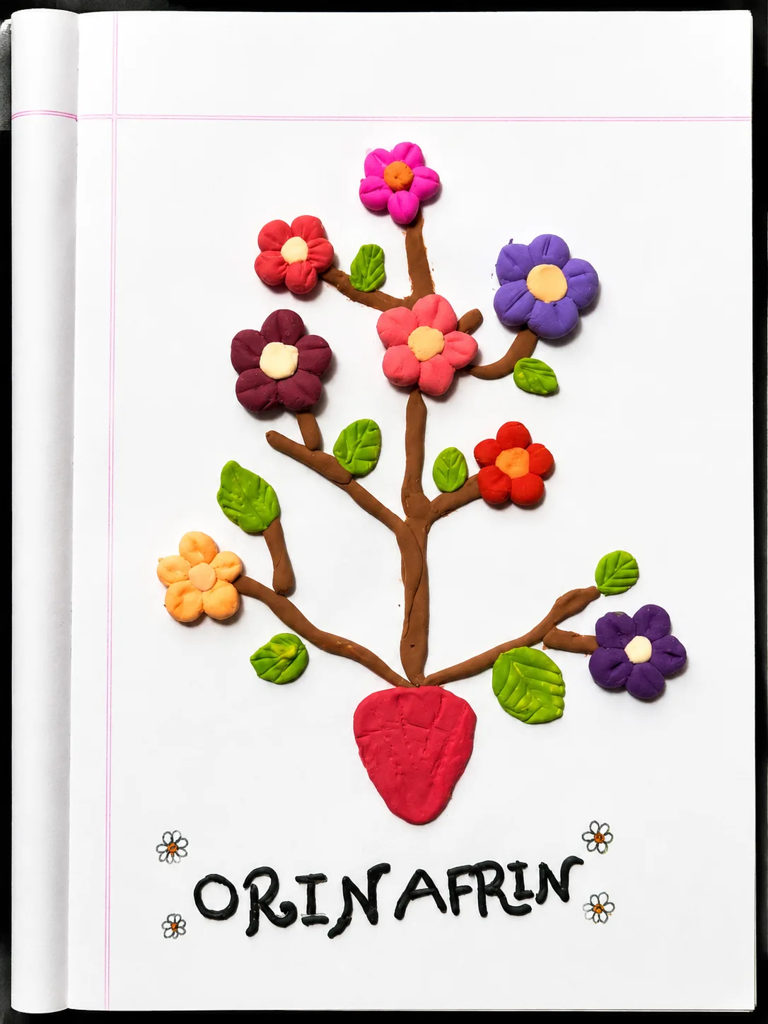 Orin's flower heart tree craft with colorful flowers, green leaves, and a red heart.